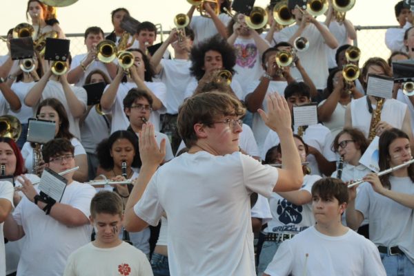 Drum Major Ben Shaffer directs the band in the stands at the Carroll Game on Sept. 6.